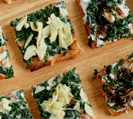 Assorted veggie flatbreads with creamy toppings served at Après Café in SUMMIT One Vanderbilt.