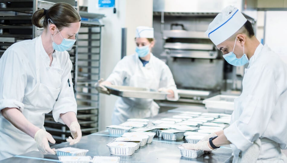 Kitchen workers preparing meals as part of FOOD1st's effort to expand food access in New York City.