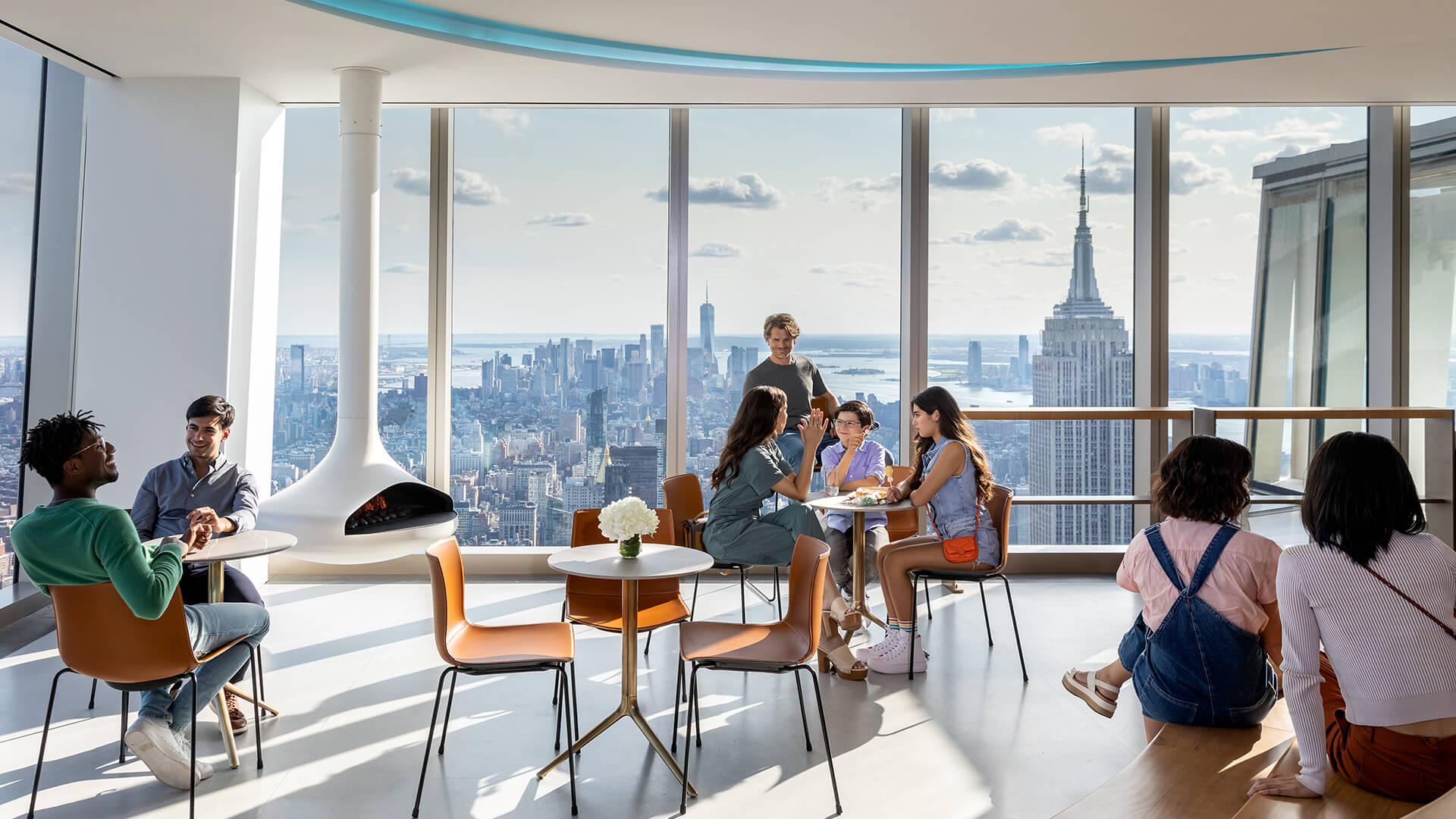 Guests seated at a Midtown Manhattan cade, smiling as they take in the captivating view of New York.